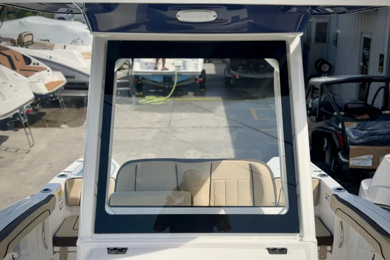 Slide: The Image of 2026 Yamaha Boats 252 FSH Sport interior view at a marina. - 32
