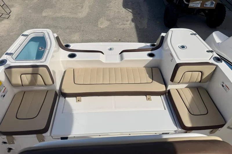 Slide: The Image of 2026 Yamaha Boats 252 FSH Sport interior with beige seating and storage compartments. - 9