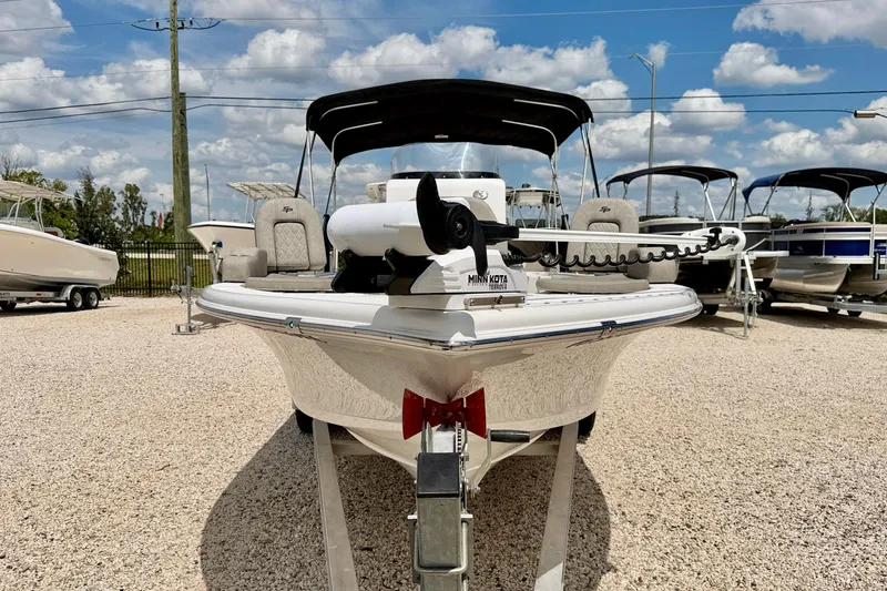 Slide: The Image of 2022 Sea Pro 248 Bay boat on trailer, displayed outdoors under blue sky. - 2