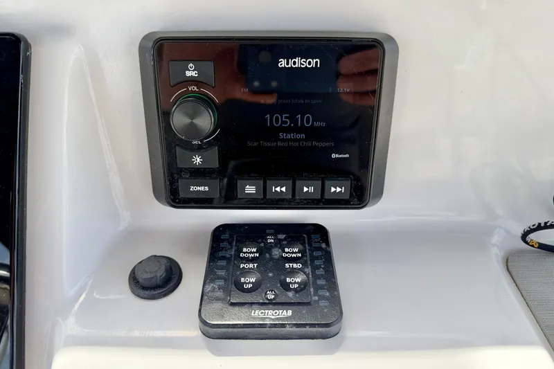 Slide: The Image of Audio control panel on a 2022 Sea Pro 248 Bay boat dashboard. - 20