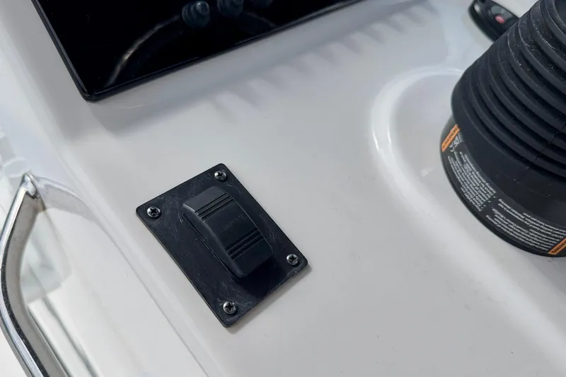 Slide: The Image of Close-up of 2022 Sea Pro 248 Bay boat control panel with switch and handle. - 21