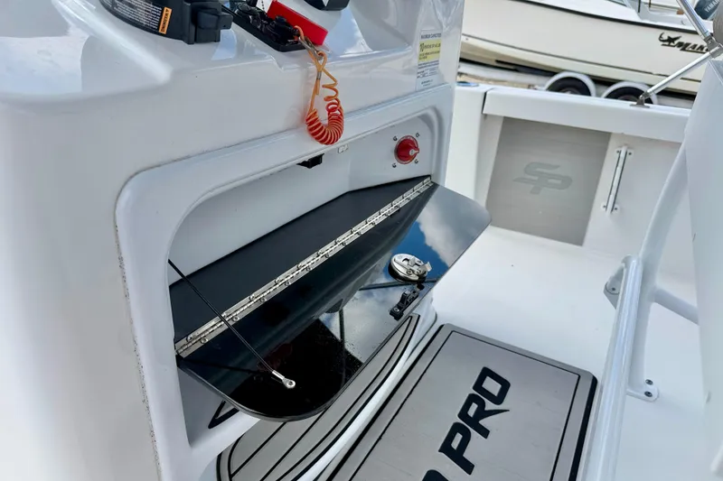 Slide: The Image of 2022 Sea Pro 248 Bay boat interior with storage compartment and safety features. - 22