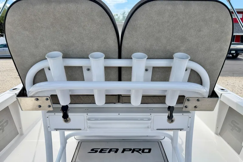 Slide: The Image of 2022 Sea Pro 248 Bay boat seat with rod holders and storage compartments. - 23