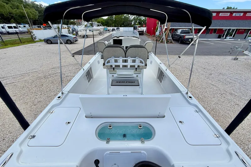 Slide: The Image of 2022 Sea Pro 248 Bay boat interior with seating and storage compartments. - 24