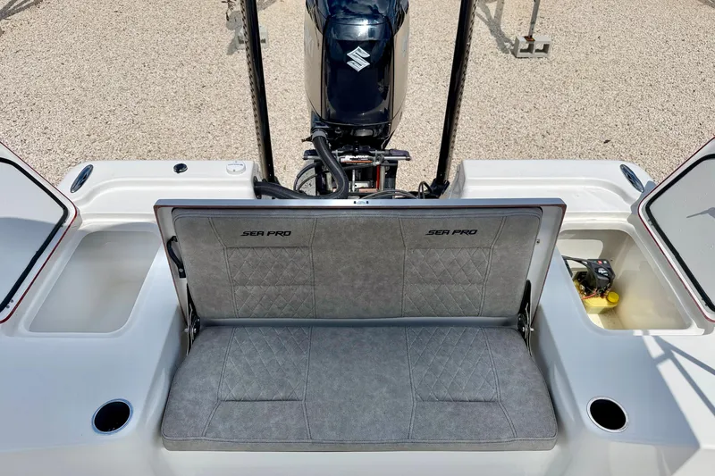 Slide: The Image of 2022 Sea Pro 248 Bay boat with cushioned seating and storage compartments. - 25