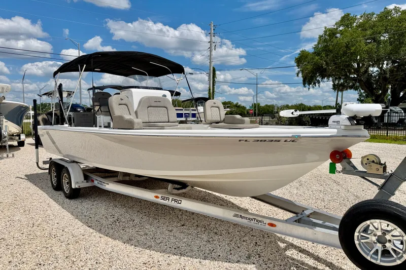 Slide: The Image of 2022 Sea Pro 248 Bay boat on trailer under clear blue sky. - 3