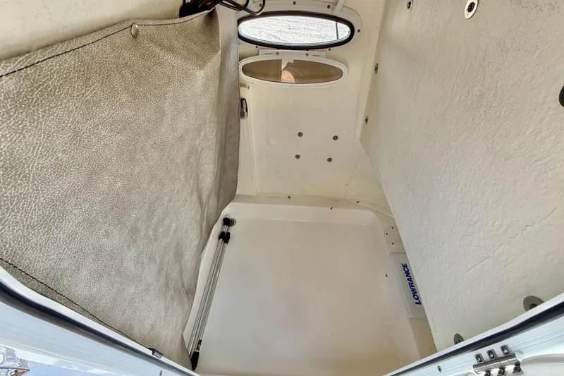 Slide: The Image of Interior cabin of 2022 Sea Pro 248 Bay boat, featuring storage space and Lowrance equipment. - 31