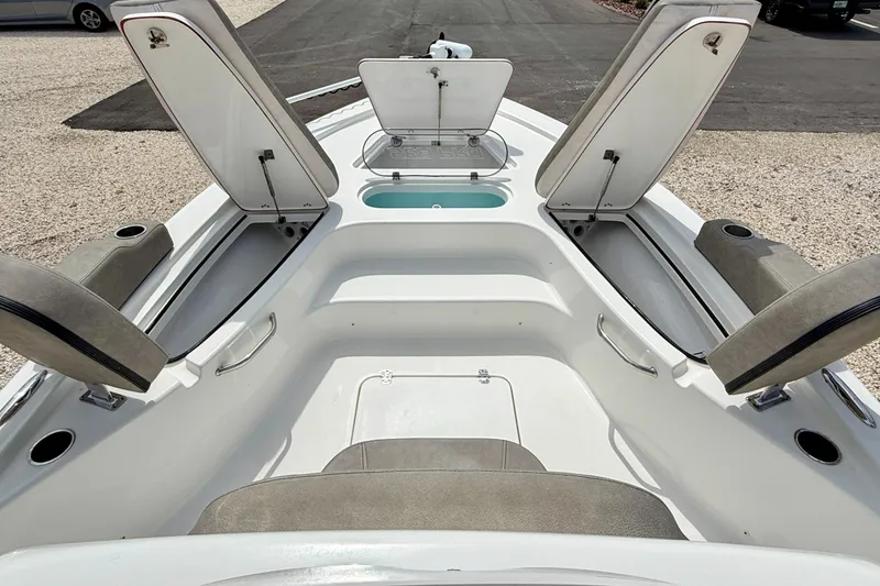 Slide: The Image of 2022 Sea Pro 248 Bay boat interior with open storage compartments and seating. - 32