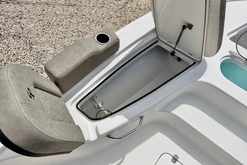 Slide: The Image of 2022 Sea Pro 248 Bay boat interior with open storage compartment and cushioned seating. - 33
