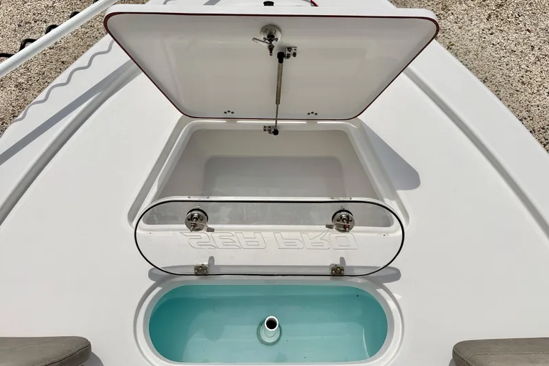 Slide: The Image of 2022 Sea Pro 248 Bay boat livewell with open lid, showcasing interior design. - 35