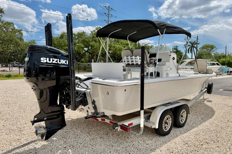 Slide: The Image of 2022 Sea Pro 248 Bay boat with Suzuki engine on a trailer, parked outdoors. - 5