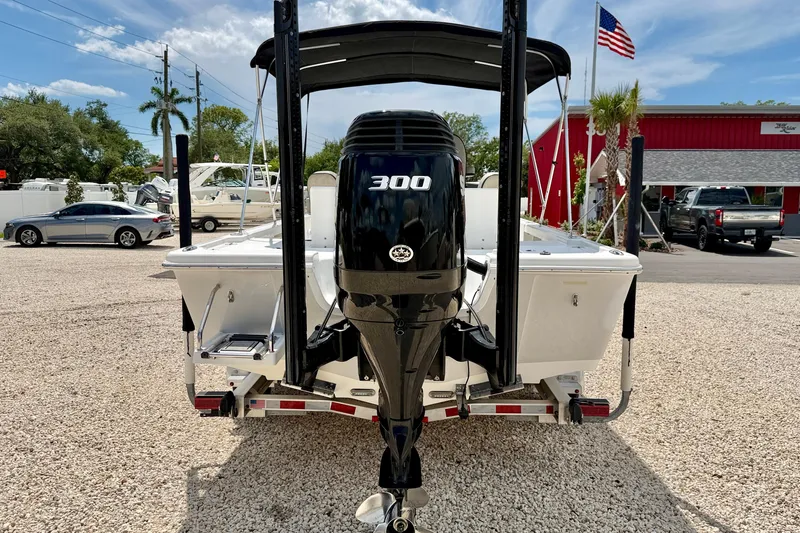 Slide: The Image of 2022 Sea Pro 248 Bay boat with powerful 300 horsepower engine, parked outdoors. - 6