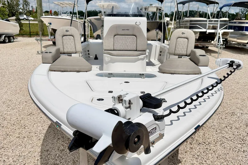 Slide: The Image of 2022 Sea Pro 248 Bay boat with seating and trolling motor, displayed outdoors. - 8