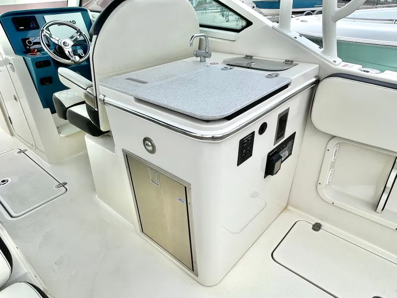 Slide: The Image of Interior of 2020 Stingray 269 DC with helm and sink. - 24