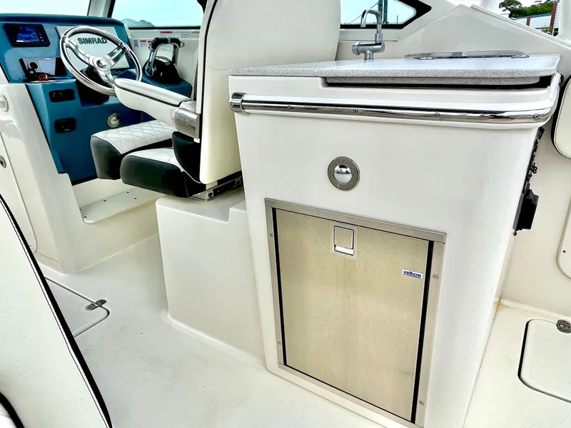 Slide: The Image of Interior of a 2020 Stingray 269 DC boat with helm and sink. - 25