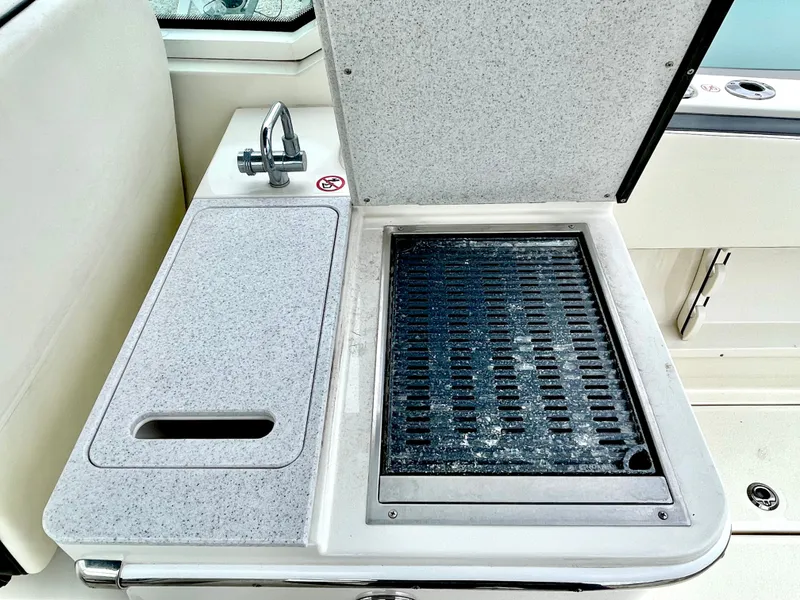 Slide: The Image of 2020 Stingray 269 DC boat kitchenette with sink and grill. - 26