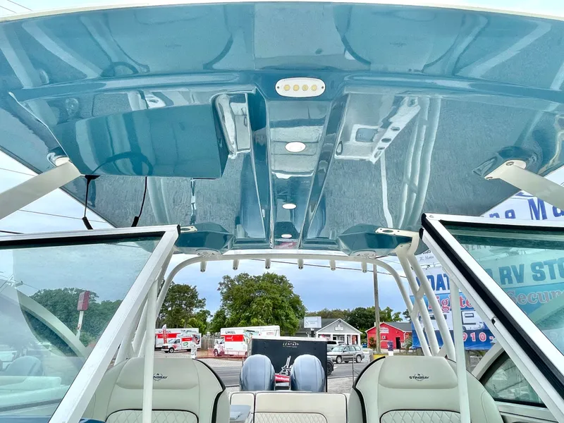 Slide: The Image of Interior view of a 2020 Stingray 269 DC boat with blue roof. - 40