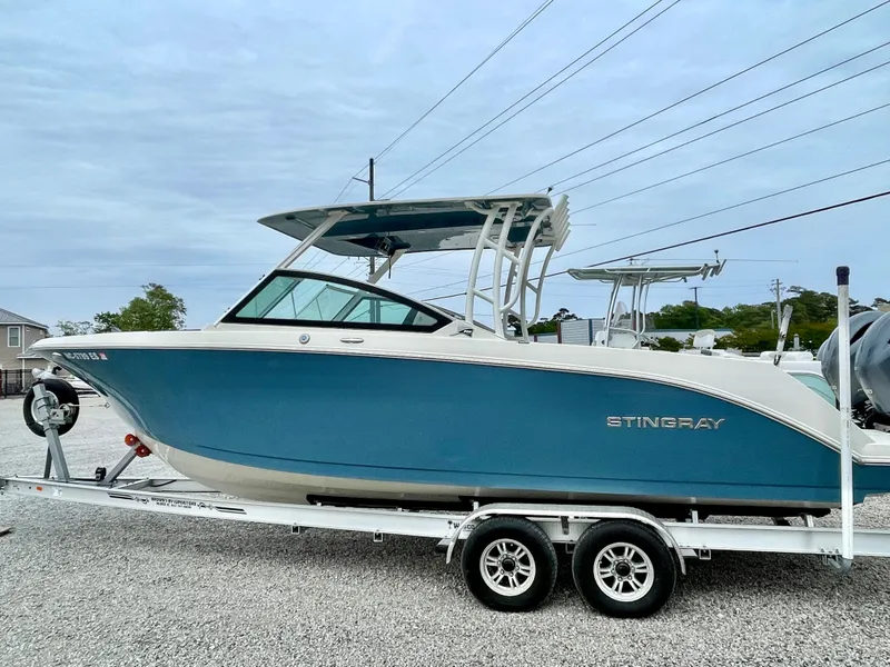Slide: The Image of 2020 Stingray 269 DC boat on trailer, blue and white. - 6