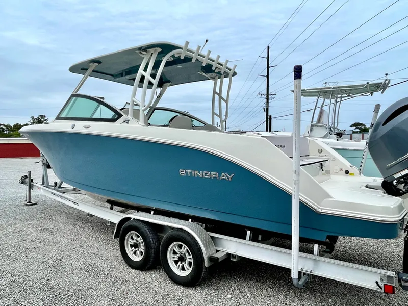 Slide: The Image of 2020 Stingray 269 DC boat on trailer, blue and white design. - 8