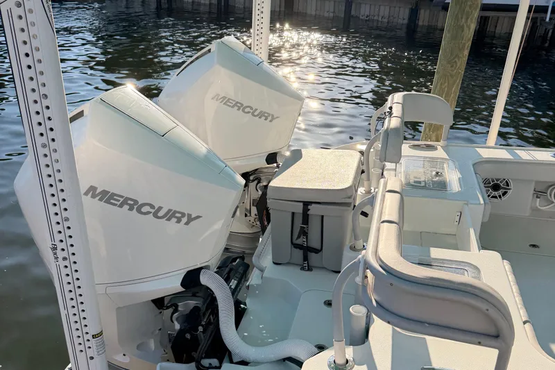 Slide: The Image of 2020 Costa Custom Boats 264 HC with dual Mercury engines docked by the water. - 14