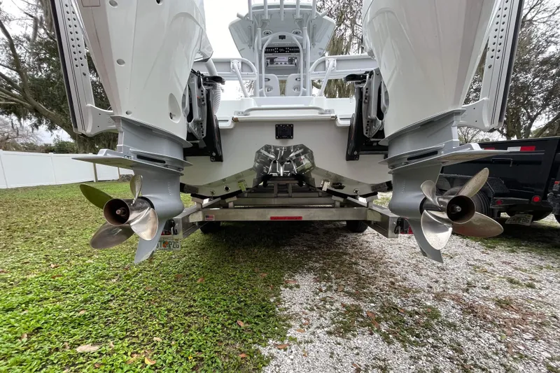 Slide: The Image of 2020 Costa Custom Boats 264 HC on trailer, showcasing dual outboard motors and propellers. - 16