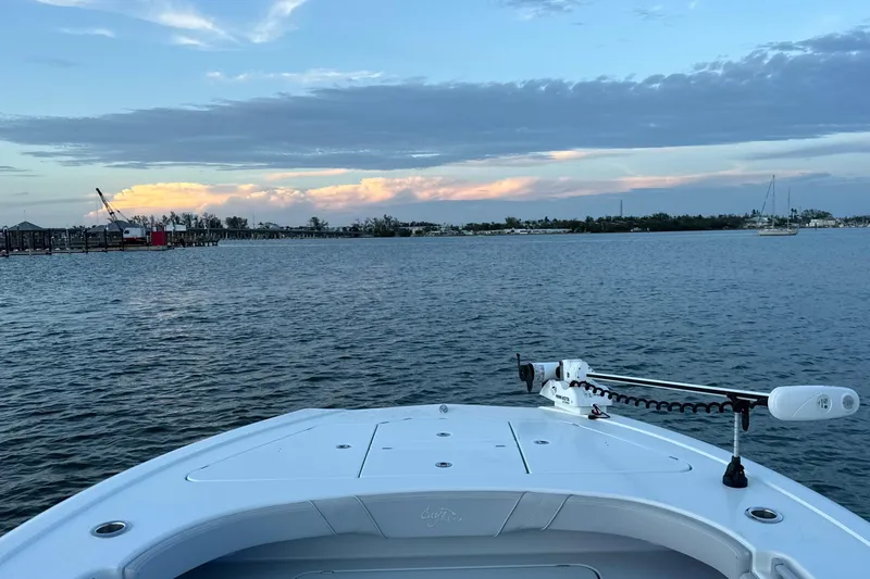 Slide: The Image of Bow view of 2020 Costa Custom Boats 264 HC on calm water at sunset. - 18