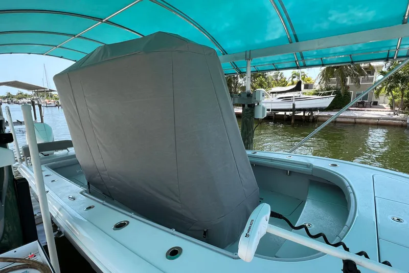 Slide: The Image of 2020 Costa Custom Boats 264 HC under a canopy, docked by the water. - 19