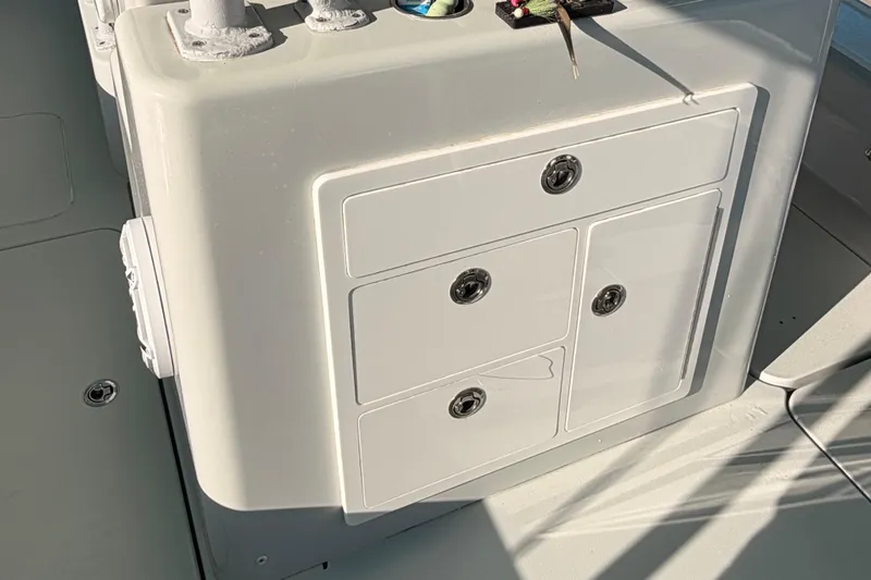 Slide: The Image of Storage compartment on a 2020 Costa Custom Boats 264 HC, featuring multiple drawers. - 22