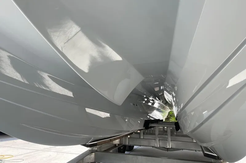 Slide: The Image of Underneath view of a 2020 Costa Custom Boats 264 HC hull on a trailer. - 24
