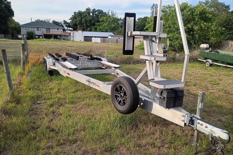 Slide: The Image of Trailer for 2020 Costa Custom Boats 264HC on grassy field. - 27