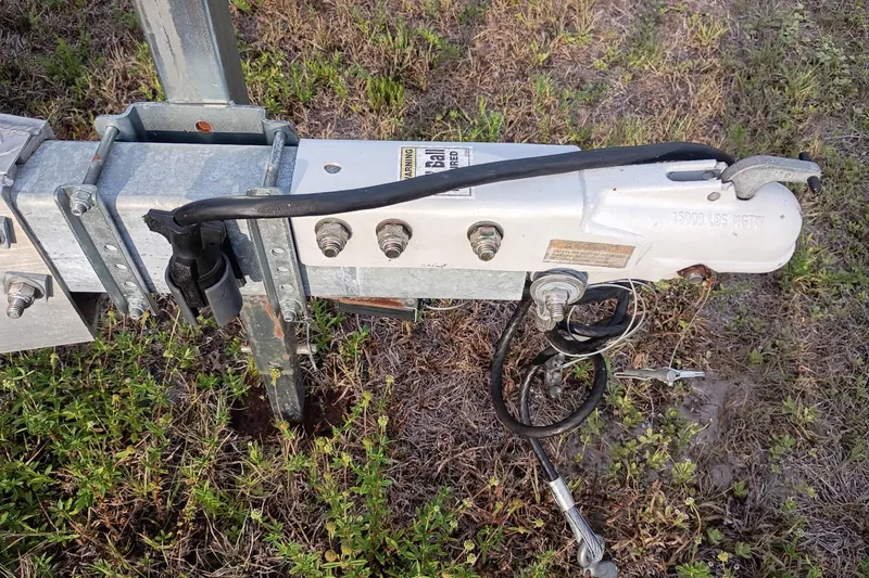 Slide: The Image of Trailer hitch of a 2020 Costa Custom Boats 264HC on grassy terrain. - 32
