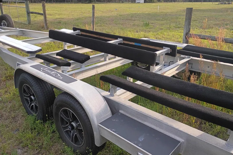 Slide: The Image of Trailer for 2020 Costa Custom Boats 264HC, parked on grassy field. - 33