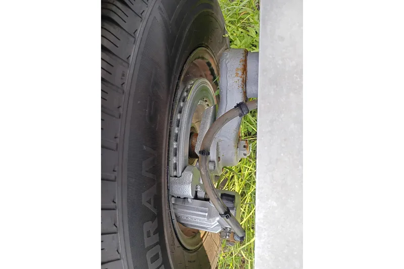 Slide: The Image of Close-up of a Costa Custom Boats 264HC 2020 trailer wheel and brake system. - 35