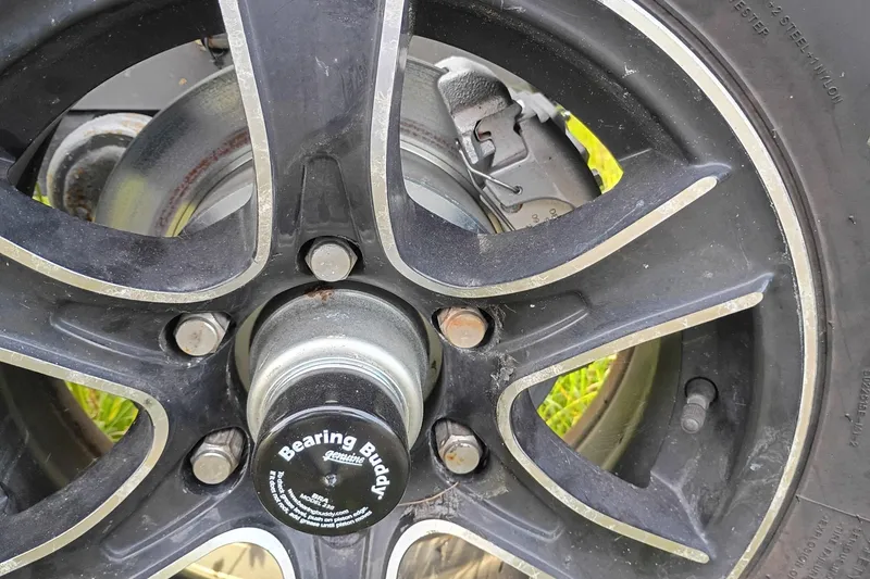 Slide: The Image of Close-up of a 2020 Costa Custom Boats 264HC wheel with Bearing Buddy hub. - 36