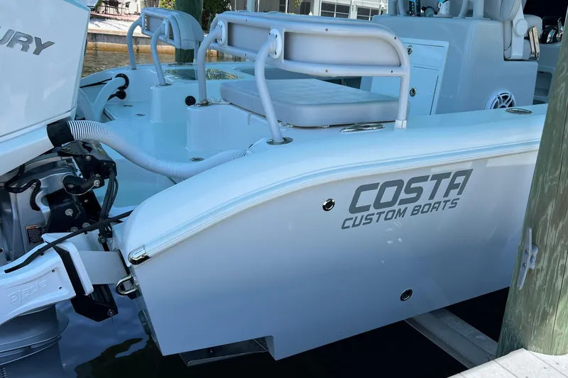 Slide: The Image of 2020 Costa Custom Boats 264 HC docked, showcasing sleek design and Mercury engine. - 5