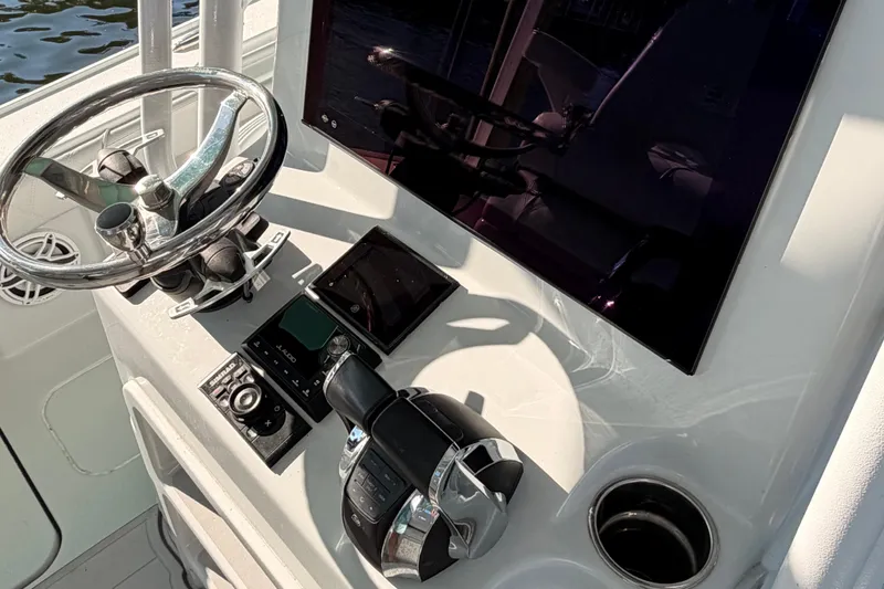 Slide: The Image of Helm of 2020 Costa Custom Boats 264 HC with steering wheel and control panel. - 6