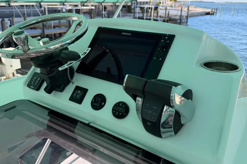 Slide: The Image of Helm of 2020 Costa Custom Boats 264 HC with steering wheel and navigation controls. - 9