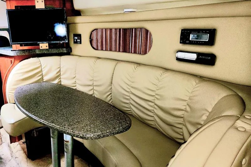 Slide: The Image of Interior of 2005 Rinker Fiesta Vee 320 with beige seating and a granite-style table. - 11
