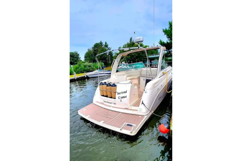Slide: The Image of 2005 Rinker Fiesta Vee 320 boat docked, featuring spacious deck and sleek design. - 15