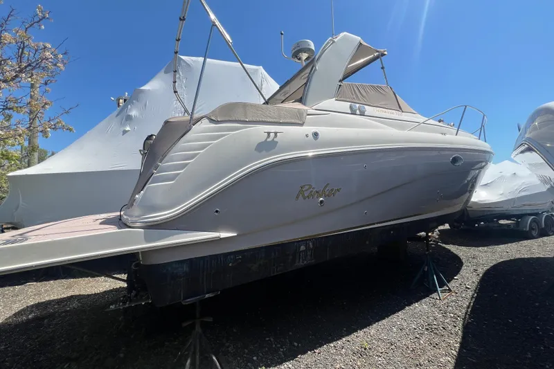 Slide: The Image of 2005 Rinker Fiesta Vee 320 boat on stands, sunny day, clear blue sky. - 17