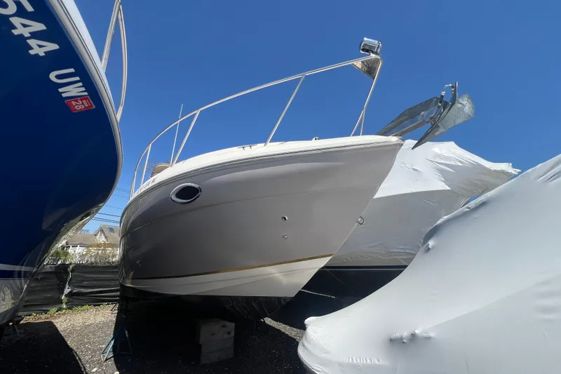 Slide: The Image of 2005 Rinker Fiesta Vee 320 boat in storage, surrounded by other covered boats. - 18