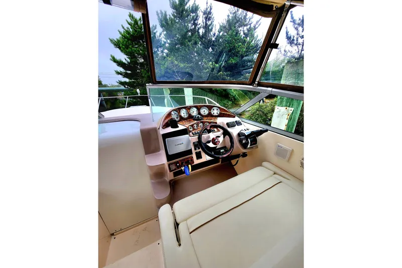 Slide: The Image of 2005 Rinker Fiesta Vee 320 boat cockpit with steering wheel and navigation instruments. - 2