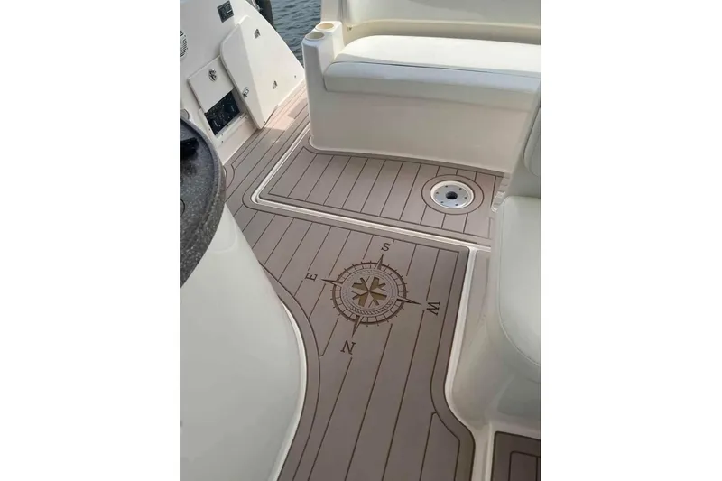 Slide: The Image of 2005 Rinker Fiesta Vee 320 boat deck with compass design and seating area. - 20