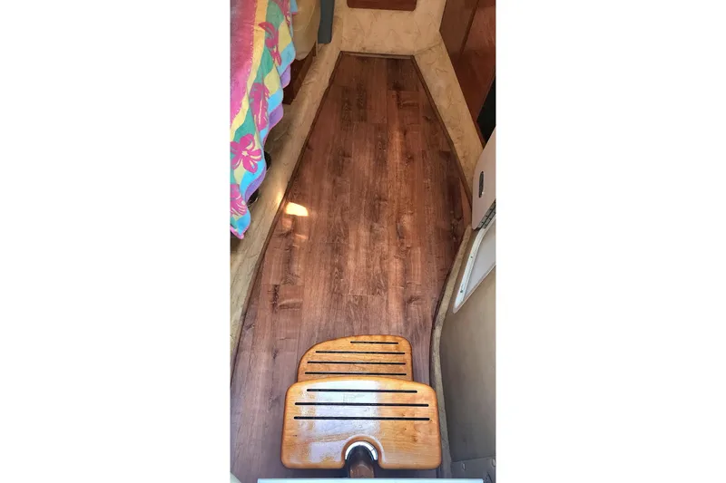 Slide: The Image of 2005 Rinker Fiesta Vee 320 interior with wood flooring and colorful bedding. - 7