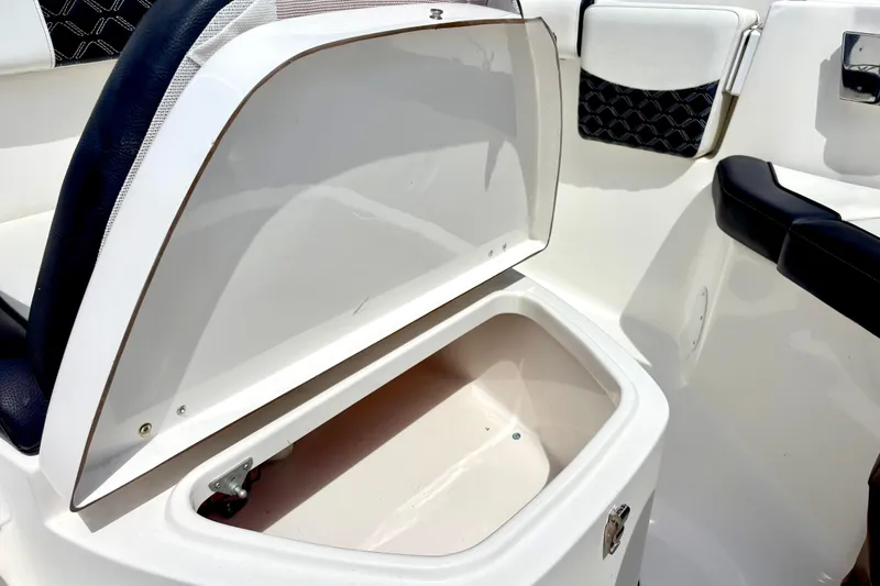 Slide: The Image of Open storage compartment on 2021 Tidewater 256 CC Adventure boat, featuring sleek interior design. - 11