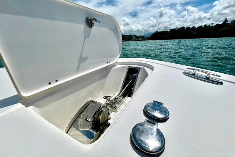 Slide: The Image of Open anchor compartment on 2021 Tidewater 256 CC Adventure boat, with scenic ocean view. - 14