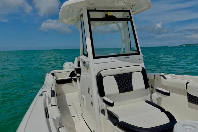 Slide: The Image of 2021 Tidewater 256 CC Adventure boat on turquoise ocean under blue sky. - 15