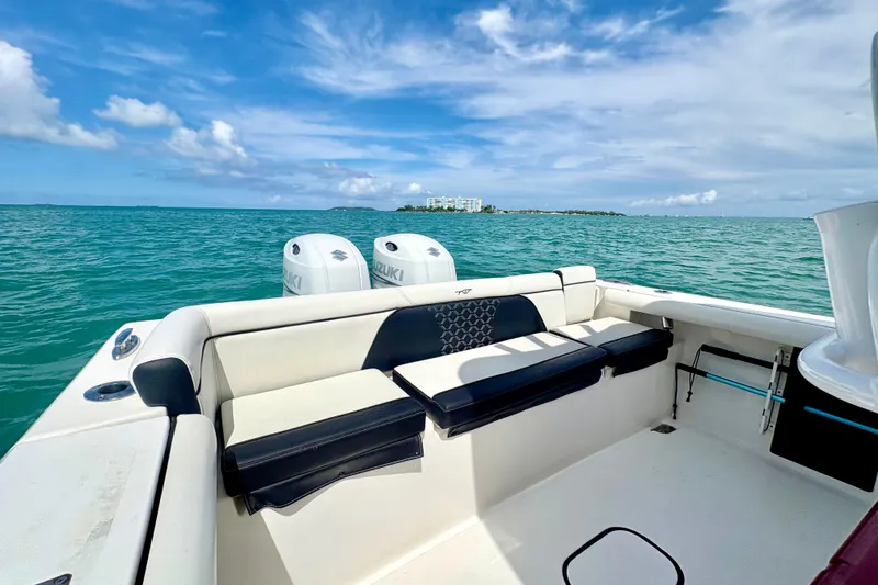 Slide: The Image of 2021 Tidewater 256 CC Adventure boat with Suzuki engines on open water. - 18