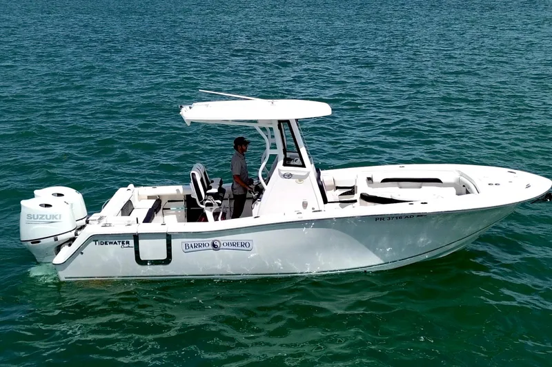 Slide: The Image of 2021 Tidewater 256 CC Adventure boat on clear blue water, side view. - 3