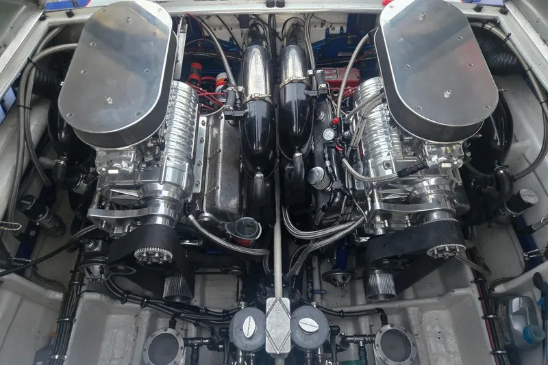 Slide: The Image of Engine compartment of a 1989 Apache 41 "The Chief" boat, showcasing dual high-performance engines. - 6